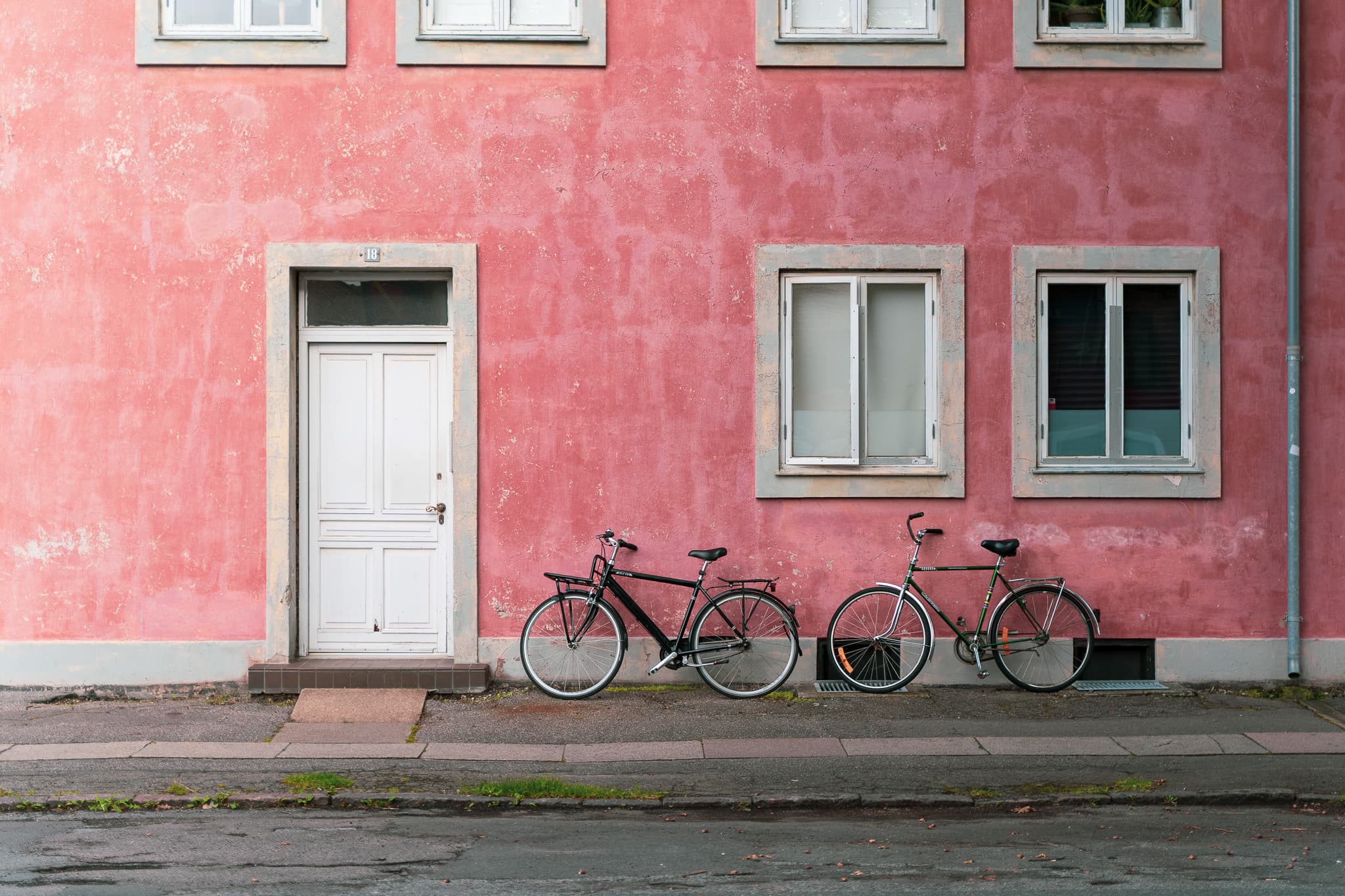 Bicycles against a pink facade in Copenhagen